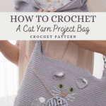 A person holds a gray crocheted bag featuring a cat and yarn ball design, showcasing its patterned lining. Text reads: "How to Crochet A Cat Crochet Project Bag Pattern.