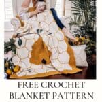 Woman sitting on an armchair with a crochet bee blanket, holding a mug, and surrounded by plants and citrus fruits, promoting a free crochet blanket pattern.