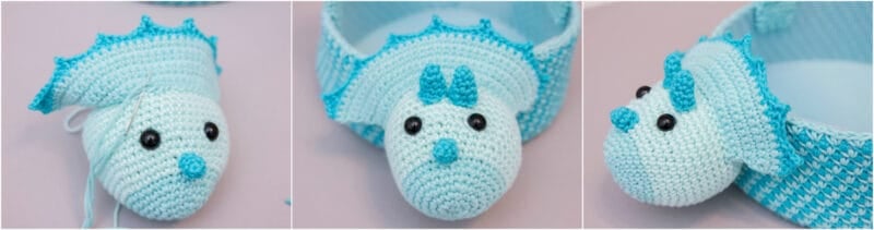 A crocheted blue and white stuffed animal in the shape of a dinosaur.