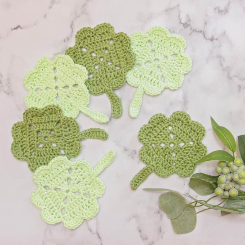 Shamrock crochet coasters, perfect for adding a touch of luck to your table decor.