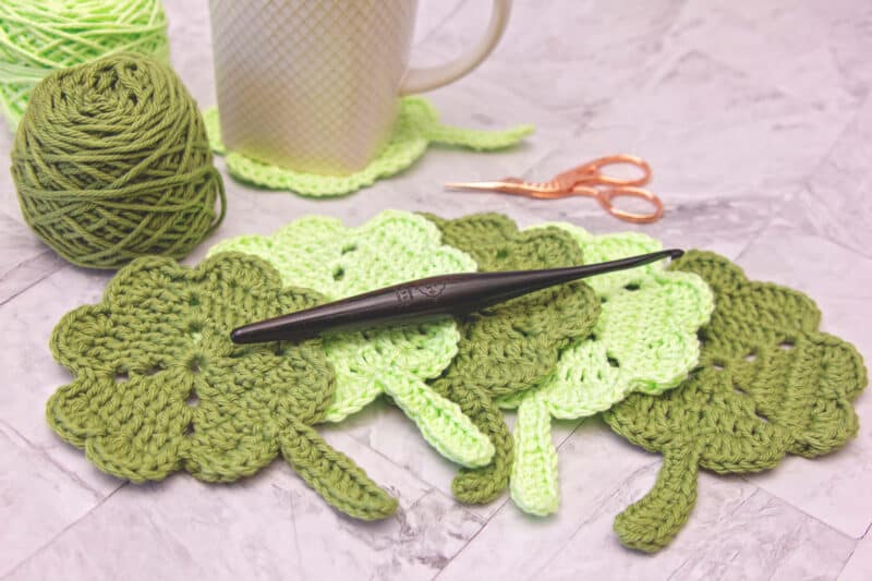 Crocheted shamrock coasters, perfect for adding a touch of St. Patrick's Day charm to your home décor. Each coaster is carefully crafted using a crochet pattern, resulting in beautiful and intricate