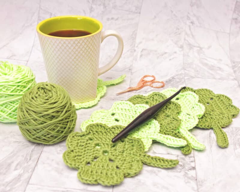 Crocheted shamrock coasters are the perfect addition to your table decor while enjoying a warm cup of coffee.