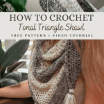 A person crochets a gray and cream Hawthorne Tonal Crochet Shawl, displayed draped over their shoulder with a decorative tassel at the tip. Text overlay offers a free pattern and video tutorial.
