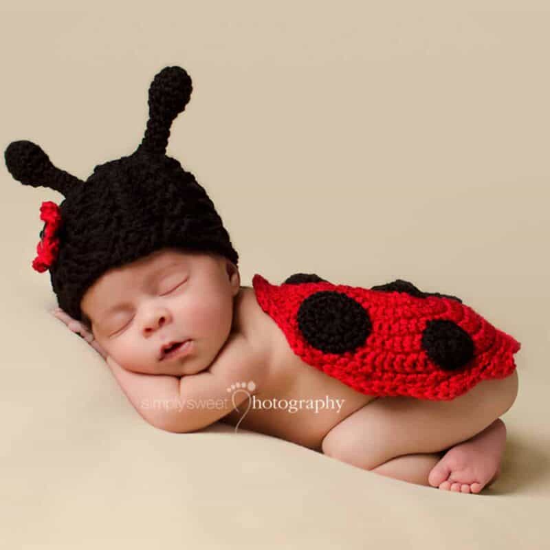 A newborn cosplaying as a ladybug with a crochet pattern.