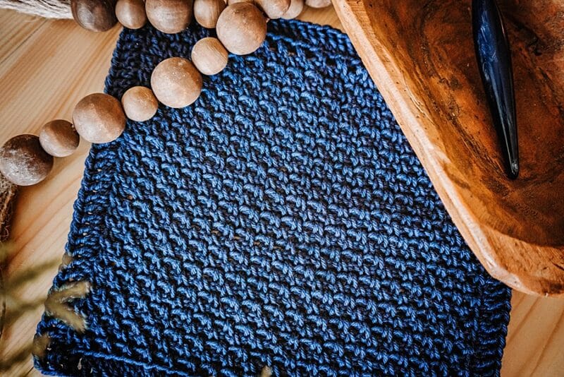 a textured blue crochet fabric