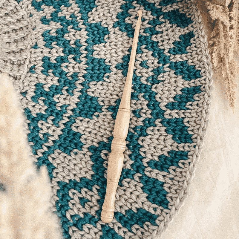 A crochet hook in a colorwork yoke