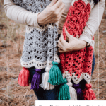Person wearing a multicolored crochet wrap with tassels, standing outdoors. Text reads, “Easy Wander Crochet Wrap – Free Pattern + Video Tutorial, www.brianakdesigns.com.”.