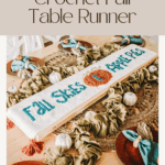 A Crochet Table Runner with the words "Fall Sets Appests," surrounded by small pumpkins and green napkins on a decorated dining table, adds a cozy seasonal touch to your autumn gatherings.