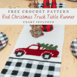 A Red Christmas Truck Table Runner featuring a red truck carrying a tree, black and white plaid accents, and festive decorations creates a charming holiday display on your wooden table.