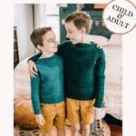Two children wearing matching crochet sweaters and shorts stand together in a cozy bedroom, smiling at each other. Text overlay promotes a crochet sweater pattern and video tutorial.