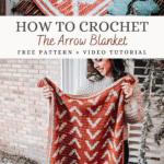 A person holds up a handmade Arrow Crochet Blanket featuring a repeating white arrow pattern on an orange background. Text overlay reads: "How to Crochet The Arrow Blanket. Free Pattern + Video Tutorial.