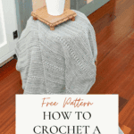 A white potted plant on a wooden tray sits atop a gray textured crochet blanket draped over a chair, with text: "How to Crochet a Garden Blanket Free Pattern.