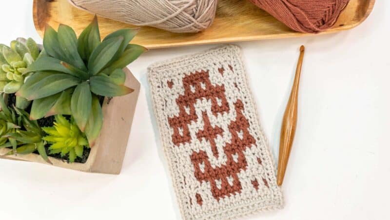 A mosaic crocheted square featuring a potted plant.