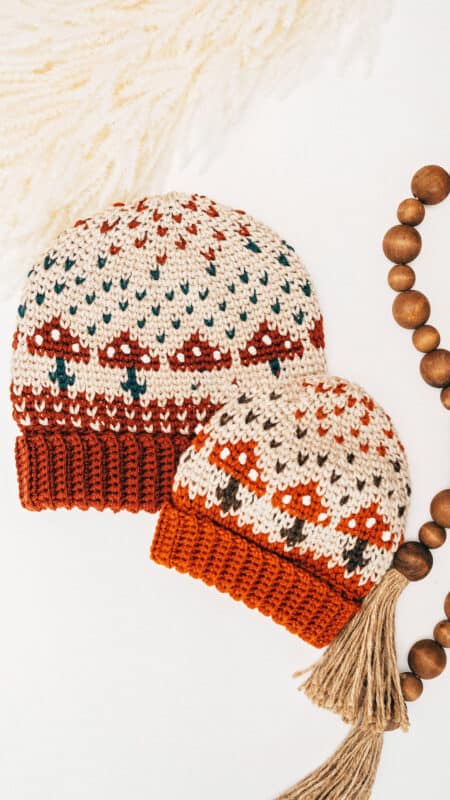 Two mushroom hats with crocheted tassels.