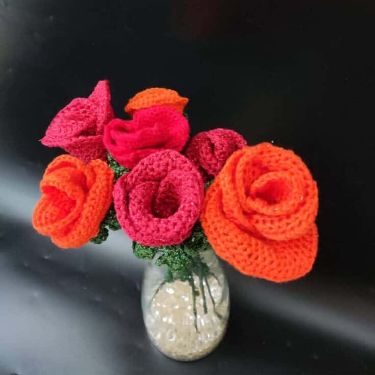Crocheted roses in a glass vase, using knit flowers.