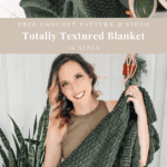 Woman holding a green textured crochet blanket, standing indoors next to plants. Text on image highlights a free textured blanket pattern, video tutorial, and 16 available sizes for this cozy project.