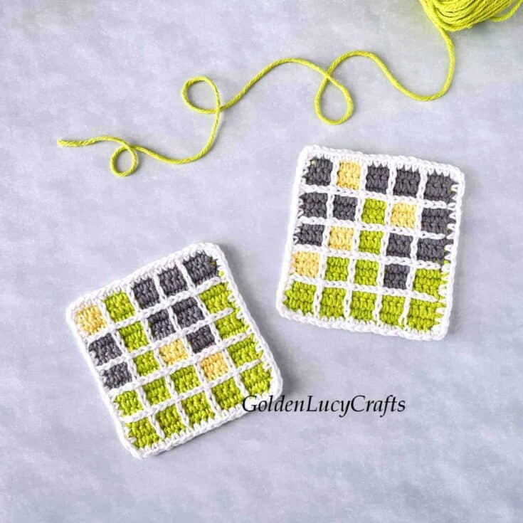 Two crocheted square coasters with yellow and grey yarn.