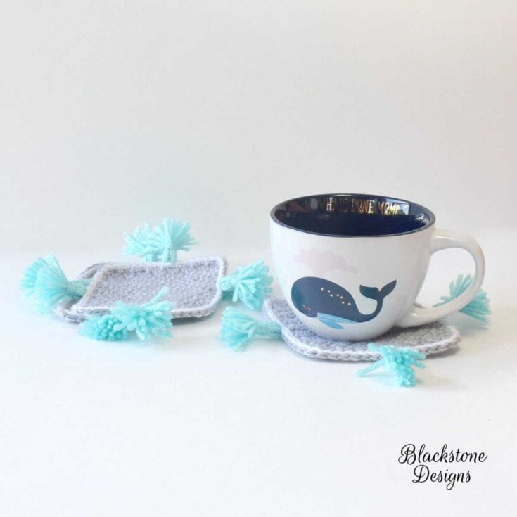 Two crocheted coasters with tassels on them.
