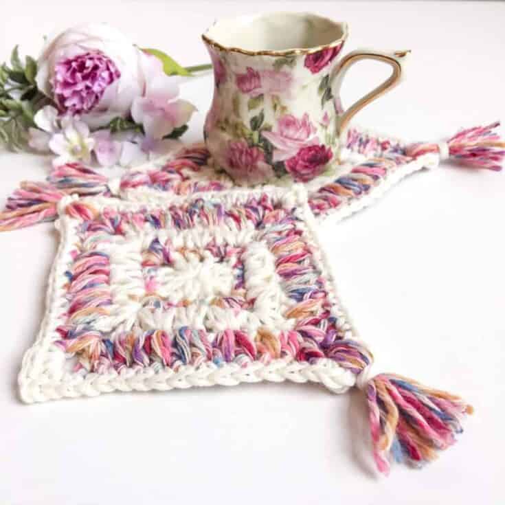 Crocheted coasters with tassels and flowers.