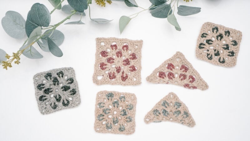 Four crocheted Granny squares adorned with eucalyptus leaves.