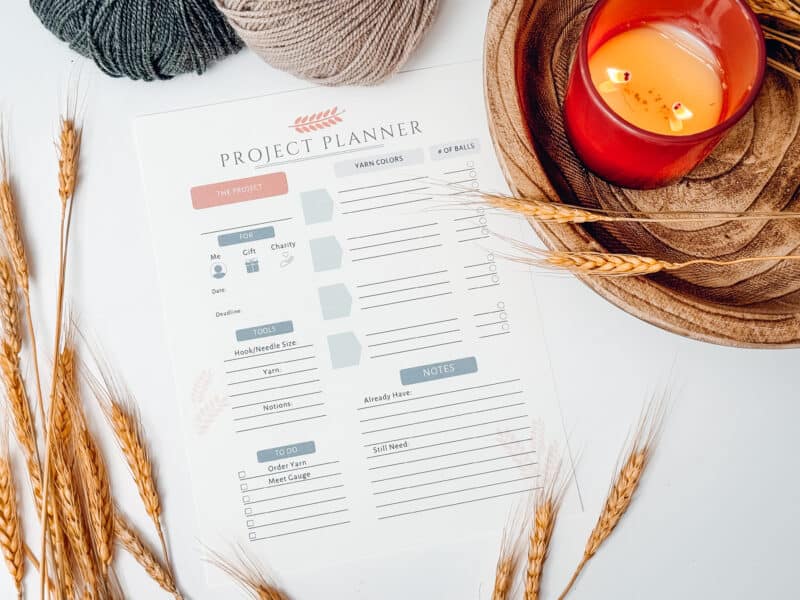 A printable project planner with yarn and wheat.