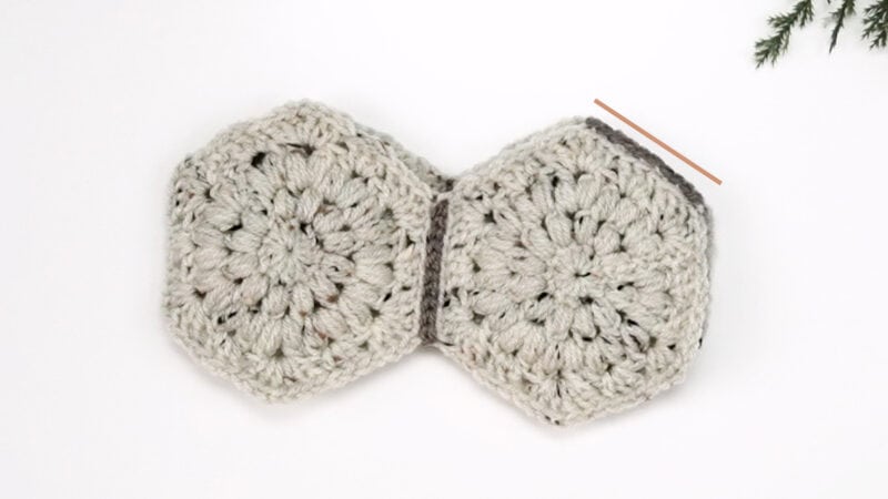 Two crocheted hexagons on a white surface for a Child Sweater.