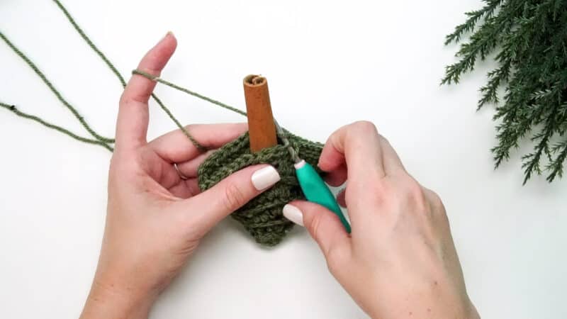 A person using a crochet hook to make a Christmas ornament for the Crochet Advent Calendar.