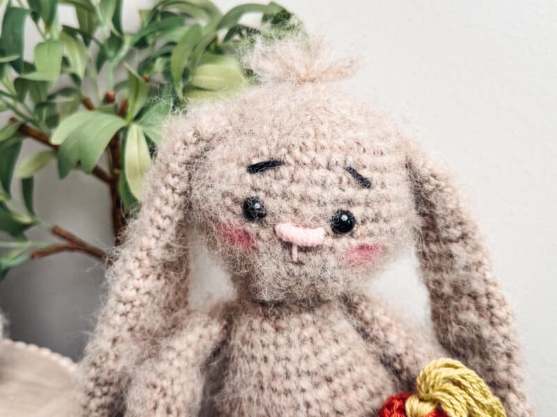 A knitted bunny sitting on a table.