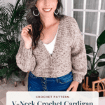 A woman wears a tan, speckled V-neck crochet cardigan with a text overlay for the pattern, sizes XS to 5X, and brianakdesigns.com.