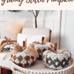 Image of a decorative table displaying crocheted pumpkins with wooden stems and burlap leaves. Text at the top reads, "Free Crochet Pattern + Video Tutorial Granny Stitch Pumpkin.