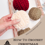 A hand holds a white crochet Christmas ornament above a tray with red and green crocheted ornaments. Text reads: "How to Crochet Christmas Ornaments: Free Pattern + Video Tutorial.