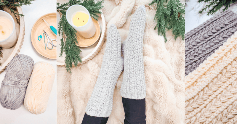 Cozy knitted socks on feet resting on a fluffy blanket, surrounded by candles, yarn, scissors, and evergreen branches.