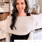 Woman wearing a cream-colored wheat stitch sweater scarf, standing indoors in a yarn-themed room. Text on image reads: “Free Winter Wheat Crochet Sweater Scarf Pattern + Video Tutorial” and “www.brianakdesigns.com”.