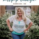 A woman models the Lollipop Summer Cardigan—a white crochet cardigan over a green top and jeans—outdoors. Discover the Free Crochet Pattern and video tutorial for this stylish piece, available in sizes XS–5X.