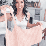 A woman holds up a light pink Wheat Stitch Tank Top in progress, smiling at the camera. Text on image reads "Light & Airy Tank Top - Free Crochet Pattern" and "www.BrianaKDesigns.com".