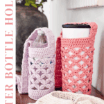 Two crocheted water bottle holders, one purple and one pink, sit on a table with water bottles inside. A few crocheted items are also laid out in the foreground.