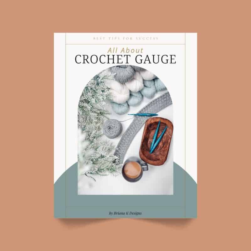 Book cover titled "All About Crochet Gauge" featuring yarn, crochet hooks, a crocheted swatch, a cup of coffee, and a sprig of greenery arranged on a surface.