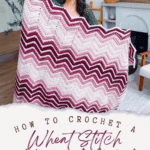 Woman holding a pink, white, and burgundy chevron-patterned crochet blanket; text below reads "How to Crochet a Wheat Stitch Chevron Blanket—Crochet Pattern + Video Tutorial.