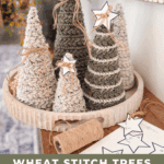 A wooden tray holds several crocheted trees in different sizes, twine, and paper star cutouts. Text at the bottom reads: "Wheat Stitch Trees Crochet Pattern + Video Tutorial 3 Sizes.