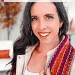 Woman smiling indoors wearing a colorful ribbed scarf; text promotes a free crochet pattern and video tutorial for a wheat stitch scarf.