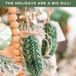 Two crocheted pickle ornaments hang on a decorated Christmas tree with a wooden bead garland and a light green ornament. Text promotes the free Wheat Stitch Crochet Pickle Ornament Pattern and video tutorial.