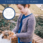 Young child wearing a crocheted cardigan pets a dog outdoors. Discover the Cascade Child Crochet Cardigan pattern—get the free crochet pattern and video tutorial for a child’s cardigan in 7 sizes, with hood and pocket directions.