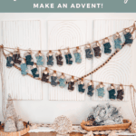 A wall display features Wheat Stitch Crochet Mini Stockings in various colors hung on string as an advent calendar, above a wooden table decorated with yarn trees and winter-themed decor.