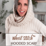 Woman wearing a knit hooded scarf in a neutral-colored room. Text on image reads: "Wheat Stitch™ Hooded Scarf, Free Pattern + Video Tutorial.