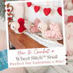 A display of crocheted snail toys in various colors on a wooden surface, surrounded by yarn and crochet tools, with text promoting a free Wheat Stitch crochet heart pattern and video tutorial.