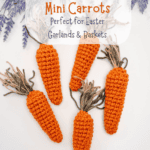 Five crocheted mini carrots with green yarn tops are arranged on a white surface, surrounded by decorative lavender flowers. Text offers a crochet pattern, video tutorial, and a matching Crochet Bunny Head Pattern for added charm.