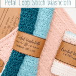 Rolled crochet washcloths in teal, blue, and cream colors with brown labels reading "Crochet Washcloth Handmade with Love," next to a pink washcloth on a white surface.