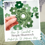 A hand holds a green crocheted shamrock above balls of green yarn and other crocheted shamrocks, with text offering a free pattern and video tutorial for St. Patrick's Day.