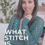 A woman with long dark hair and a gray streak wears a green Circle Leaf Lace Crochet Cardigan pattern and poses indoors. Text on the image reads: "WHAT STITCH IS THIS?.