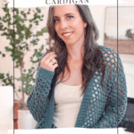 Woman wearing a light and lacy Circle Leaf Lace Crochet Cardigan pattern, standing indoors near a plant and a framed picture.